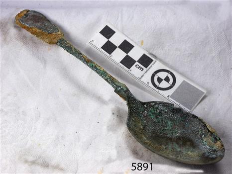 Spoon has encrustations and degradation due to time in sea water