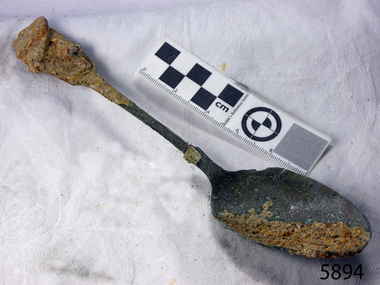 Spoon has encrustation from time under the sea