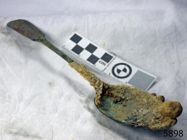 Spoon's surface is covered in encrustations from the seabed.