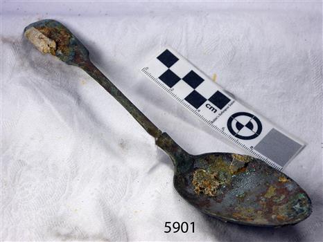Metal spoon with some degradation and encrustations
