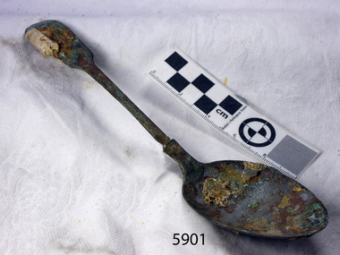 Metal spoon with some degradation and encrustations