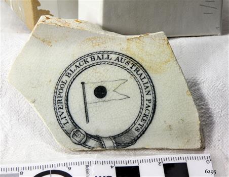 White chine piece, broken and irregular shape, with black stamp