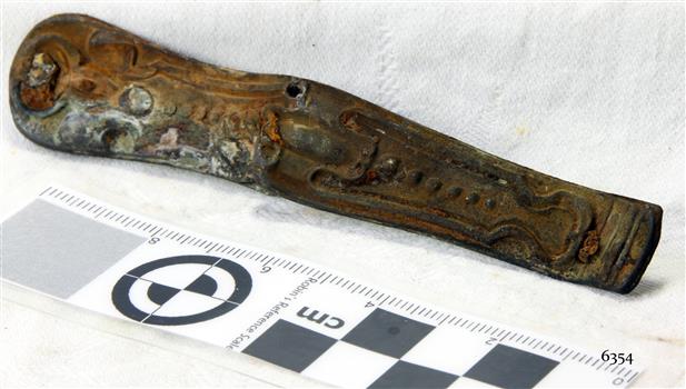 Section of a pocket knife, decorative pressed metal. Corroded.