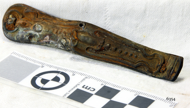 Section of a pocket knife, decorative pressed metal. Corroded.