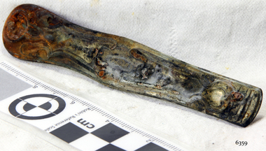 Rounded rectangular metal bar with impressed pattern and drilled holes