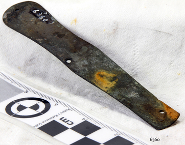 Metal pocket knife part is corroded and has drilled holes