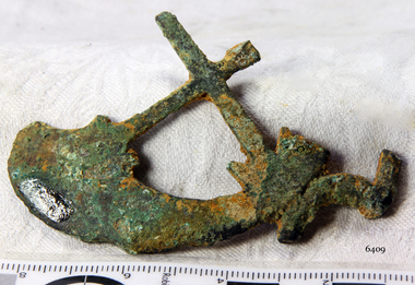 Item is a crescent with a cross attached at each end of the crescent