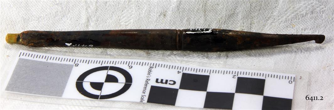Dark coloured crochet hook with a join in the centre