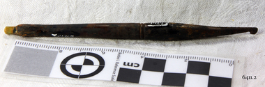 Dark coloured crochet hook with a join in the centre