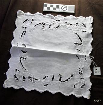 Square white cloth doily with cutwork, embroidery and scalloped edges