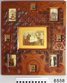 Carved wooden frame displaying nine portraits 