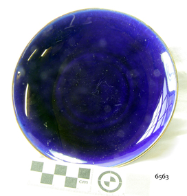 Saucer is royal blue ceramic with a gold rim