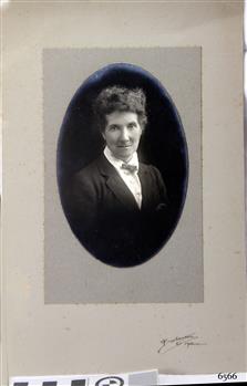 Black and white photograph mounted on card with oval cut-out