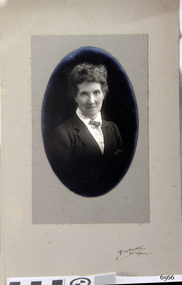 Black and white photograph mounted on card with oval cut-out
