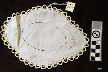 Small oval doily with crochet edge and silver grey embroidery