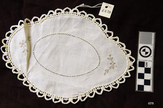 Oval tray cloth with worked edging and embroidered motifs