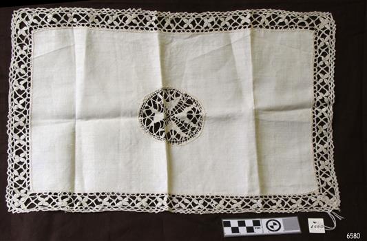 Rectangular cloth with decorative centrepiece and edging