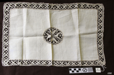 Rectangular cloth with decorative centrepiece and edging