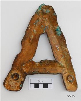 Indentations of the hollow letter have accumulated encrustations. The metal has corroded. Round indentations for the fittings.