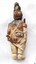 Figure is holding a sword-like weapon in its left hand