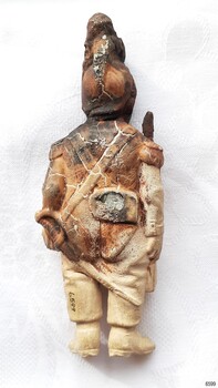 Figure is holding a sword-like weapon in its left hand