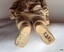 Undersides of boots have markings. Texture of surface is rough.