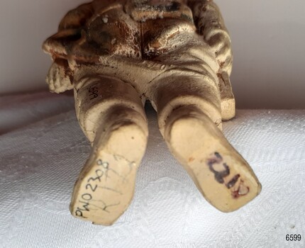 Undersides of boots have markings. Texture of surface is rough.