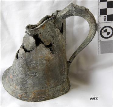 Large metal mug with flared out base and large metal handle