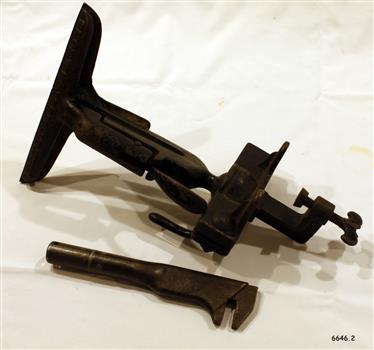 Metal vice has screw clamp to fix to bench, and spanner has adjustable pinching end