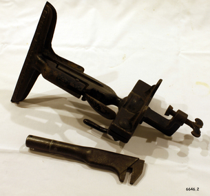 Metal vice has screw clamp to fix to bench, and spanner has adjustable pinching end