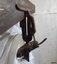 Close up of vice shows the lower clamp's lever and the jaws holding the hand saw