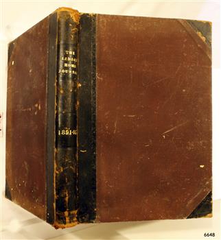 Brown hardcover, leather bound and leather reinforced corners, gold embossed lettering on spine