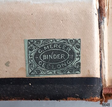 Green label with floral border and text between two oval outline shapes
