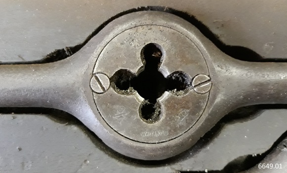 Centre of metal tool has an inscription