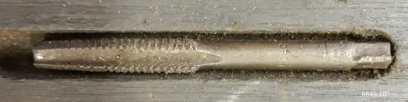 Inscription on flat square end and edge is shaped for cutting