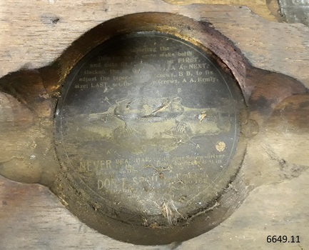 Round black label with text of maker's detains and and image