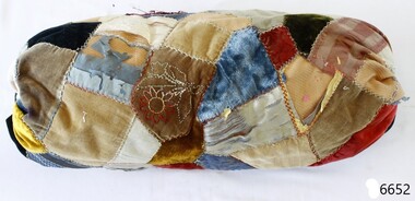 Bolster patchwork cushion of various shapes and colours of fabric