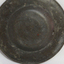 Plat's metal has scratches and a red-brown mark