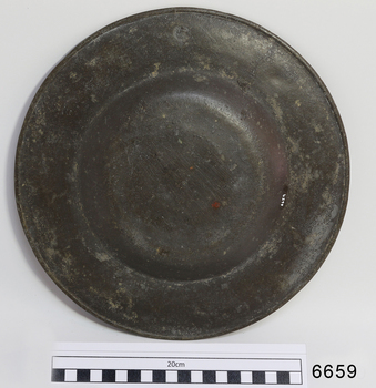 Plat's metal has scratches and a red-brown mark