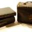 Leather covered carrying case beside two leather covered books