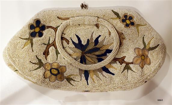 Purse has beaded floral design with round beaded handles and metal clasp