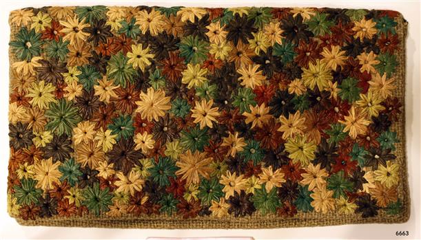 Hopsack wallet is embroidered with coloured raffia flowers