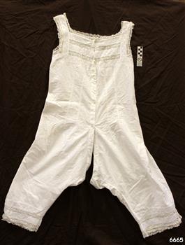 Fine white cotton undergarment with pin tucks on bodice and lace inserts. Garment combines both chemise and bloomers