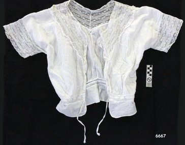 White cotton camisole with short sleeves and buttons on the front, lace trim collar and on sleeves, drawstring waist