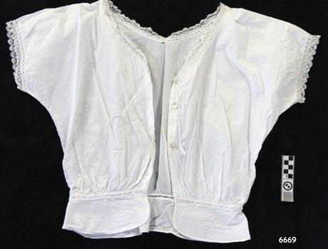 White cotton camisole with short sleeves and button through front, lace trim