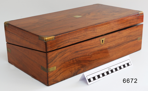 Polished wooden box with brass plaque, lock and corner protectors