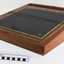 Hinged wooden box with leather surface and compartments