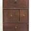 Wooden cupboard with four sections, each wit a round wooden knob