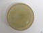 Yellow-green opaque glass cap liner, disc shape with ridge and raised centre