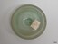 Opaque aqua cap liner, disc-shaped with a white label